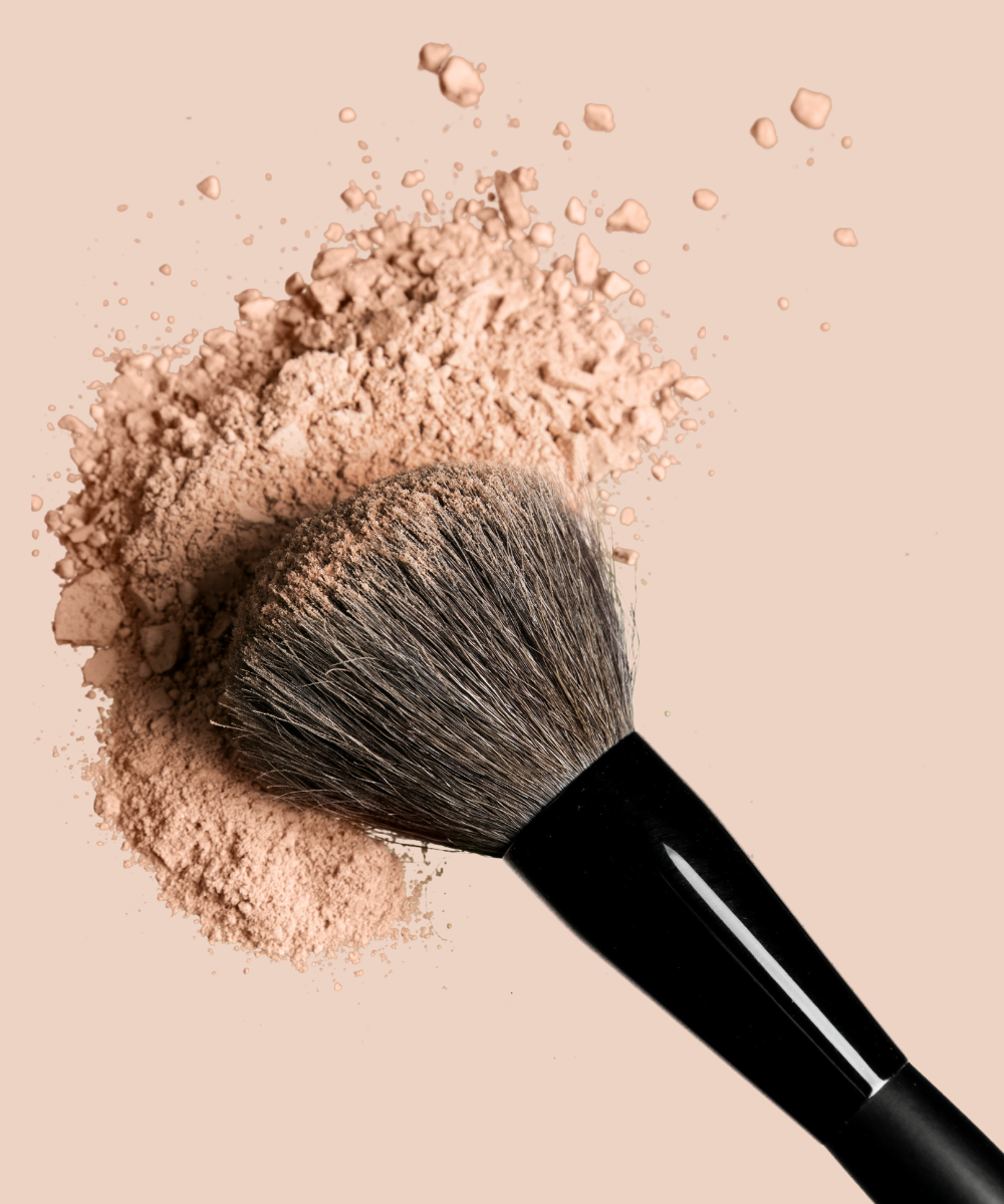 makeup brush with neutral powder on it